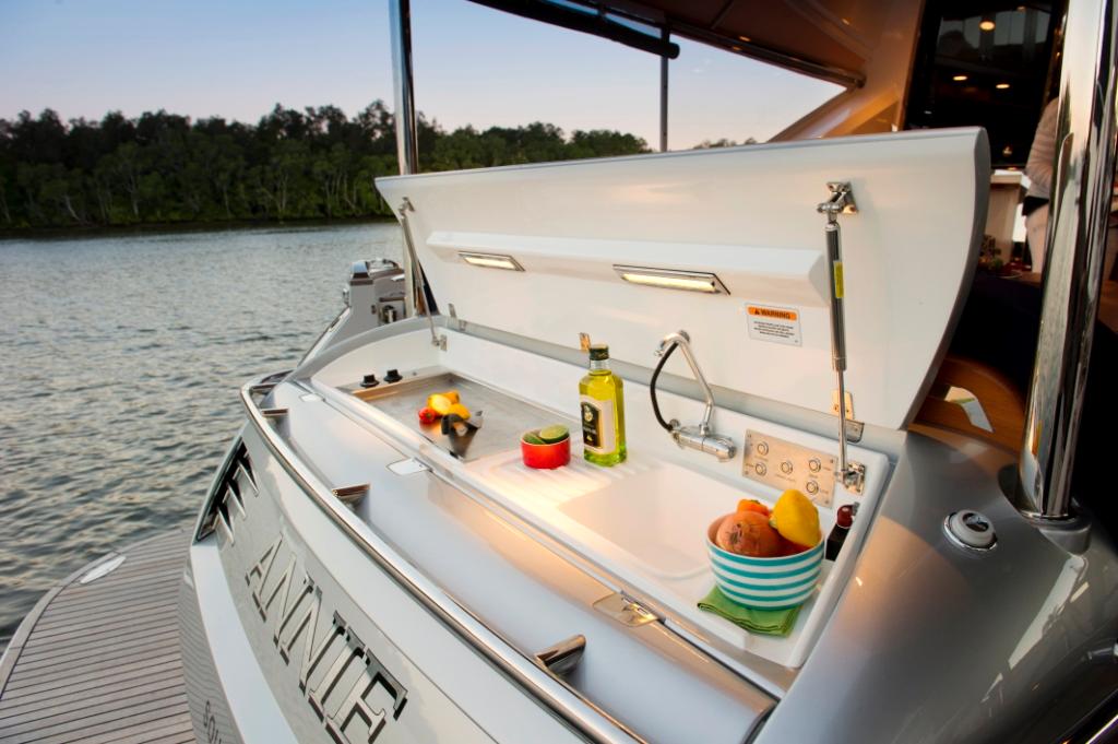 Above the tender garage is a hatch that lifts to reveal the electric BBQ with sink on board the new Belize 54 Sedan © Stephen Milne